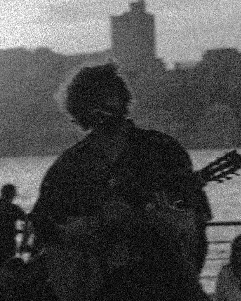 An artist performing with a guitar
